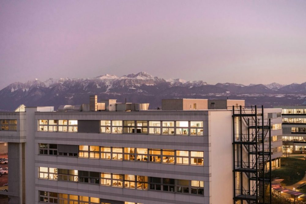 white and brown concrete building near mountain during daytime